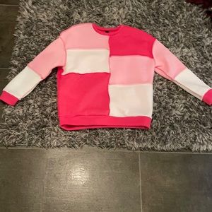 Hot pink and white crew neck sweater with inside out seam